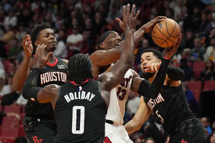 Heat center Bam Adebayo drives to the basket as Houston Rockets guard Aaron Holiday (0) and guard Fred VanVleet defend on the play during the second half at Kaseya Center.